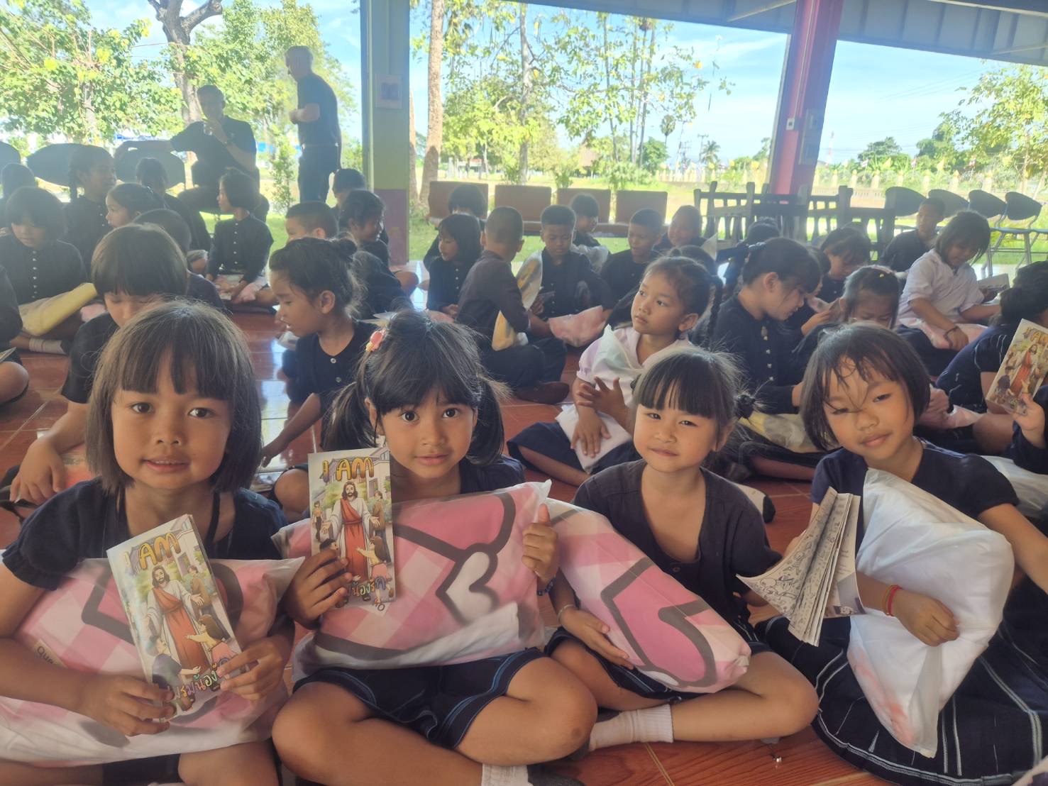 Children at a school in Thailand with donated bedding. Watch the video on YouTube